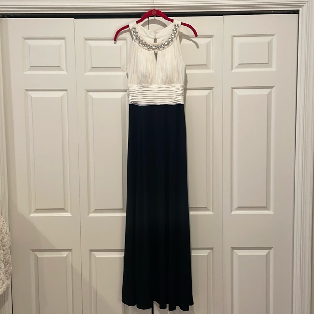 Sangria black and white long gown with crystal embellished neckline.
